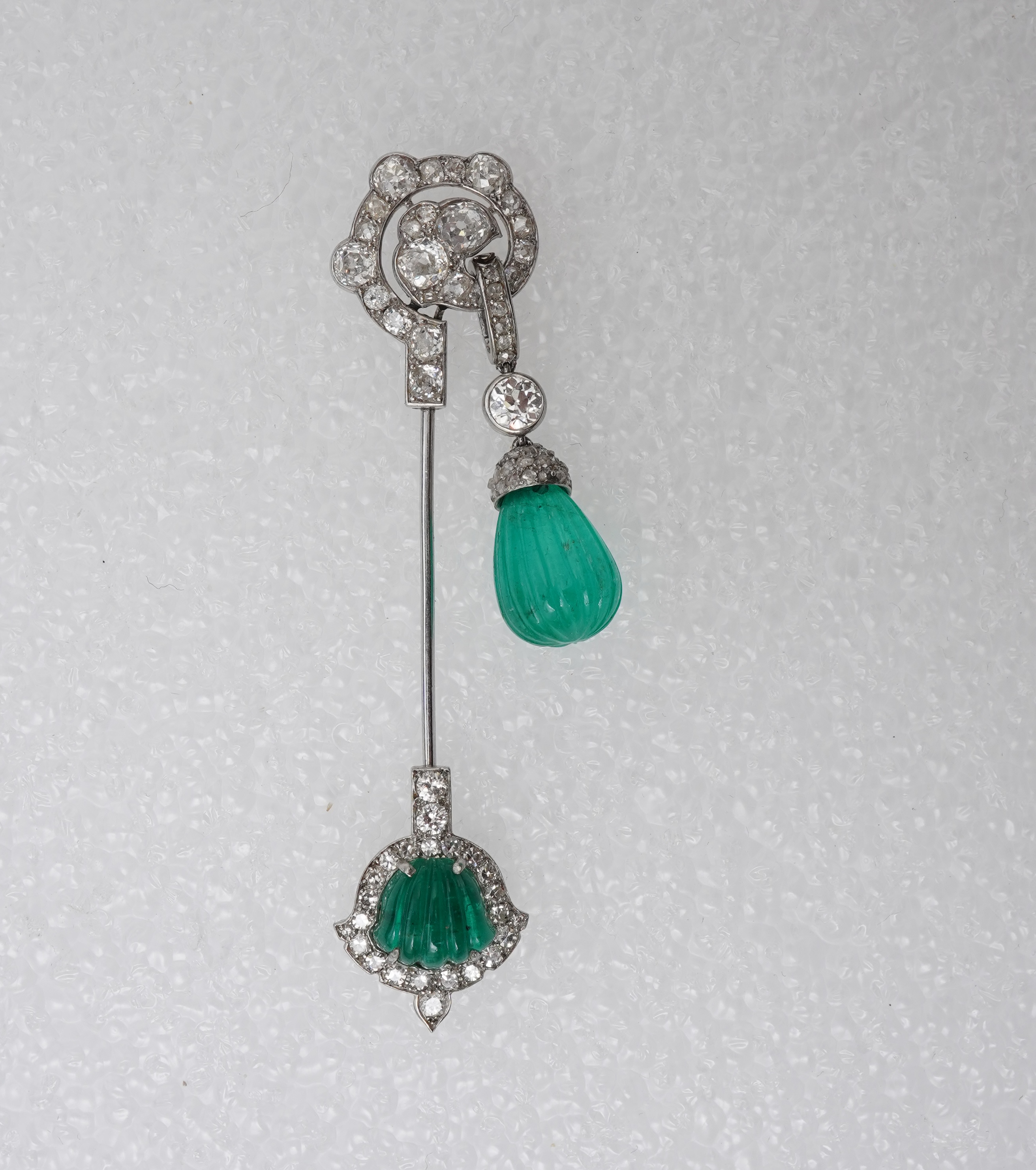 A fine Art Deco carved emerald and diamond jabot pin, circa 1925